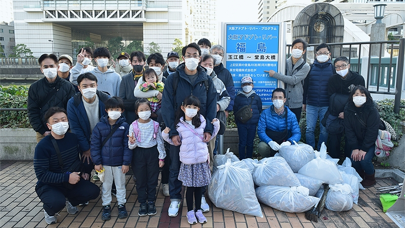 『河川清掃活動“アドプト・リバー・プログラム”』看板前での集合写真